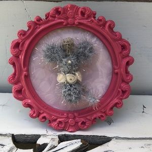 Crocheted tiny mouse on a frame